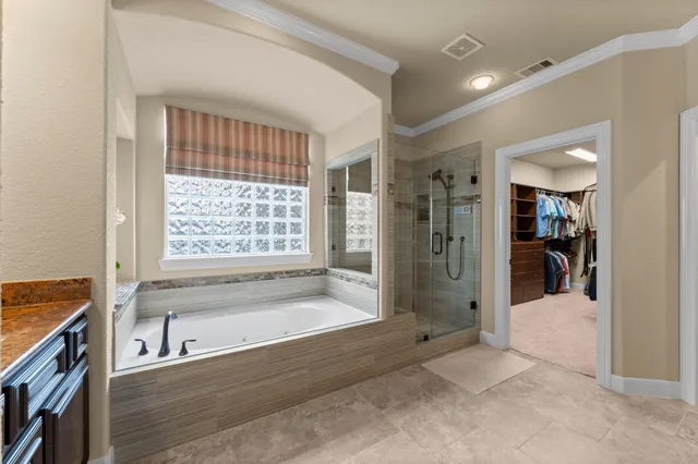 a bathroom with a bathtub and a shower