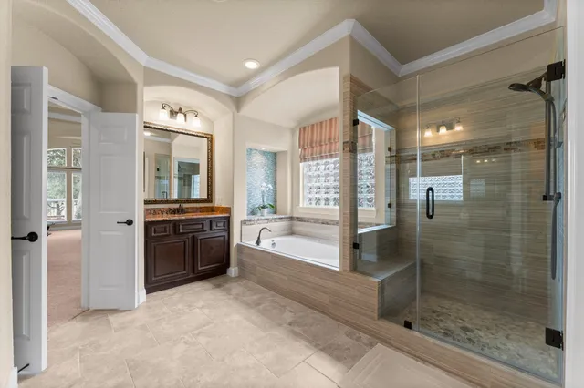 a bathroom with a tub and shower