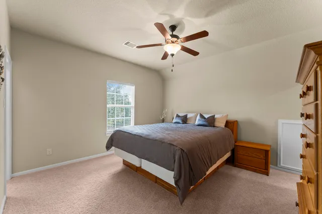 a bedroom with a bed and window