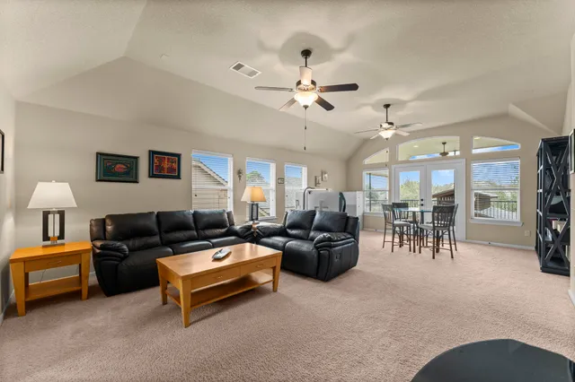 a living room with furniture and a chandelier