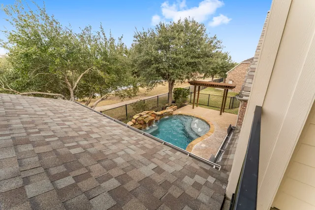 a view of a patio with table and chairs and floor to ceiling window