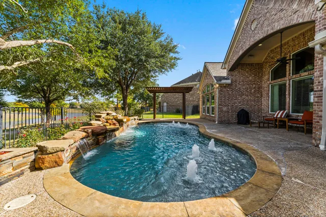 swimming pool view with a garden space