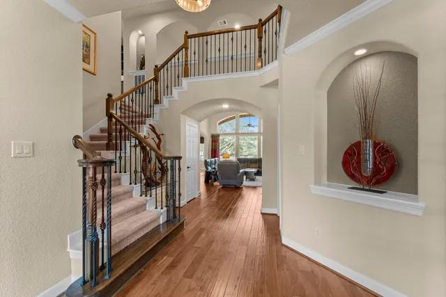 a view of entryway and hall with wooden floor