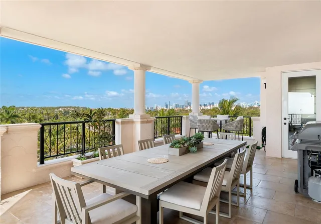 a view of a balcony dining table and chairs