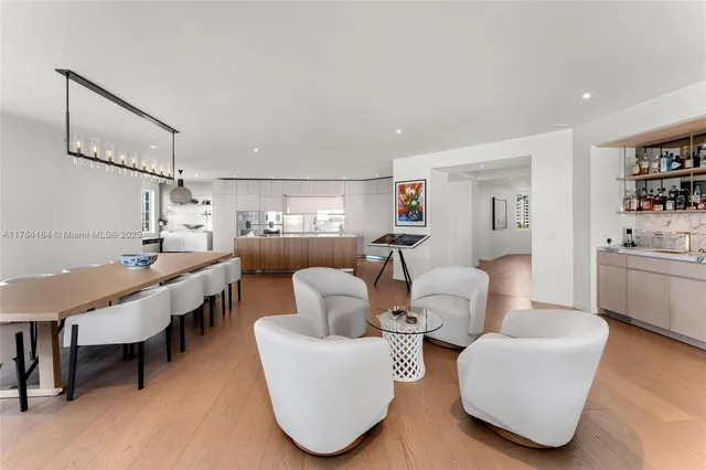 a living room with furniture and a kitchen view