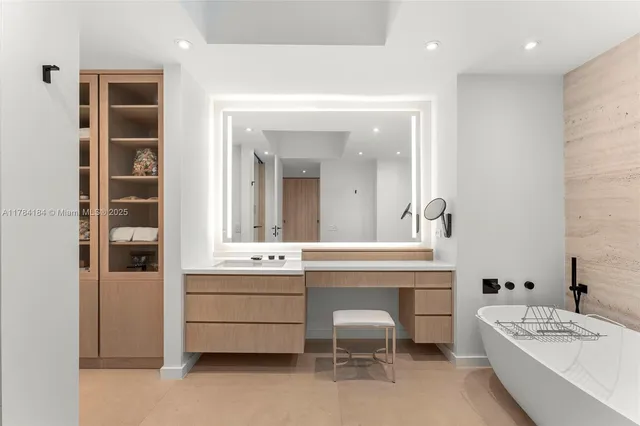 a bathroom with a sink a tub and a mirror