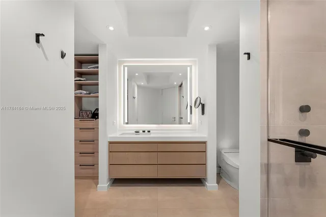 a bathroom with a double vanity sink a mirror and shower