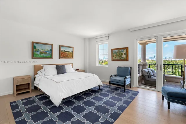 a bedroom with a bed a couch and a window