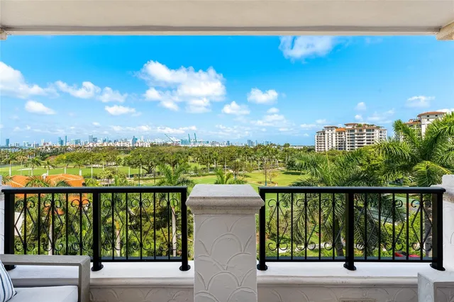 a view of a balcony with wooden floor and city view