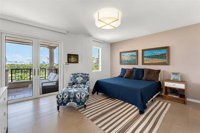 a bedroom with a large bed and a large window