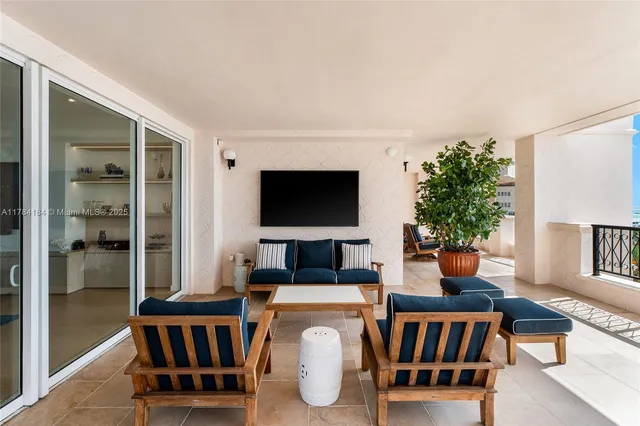 a living room with furniture a flat screen tv and a window