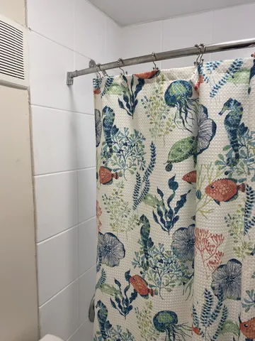 a kitchen with a sink a refrigerator and wooden floor