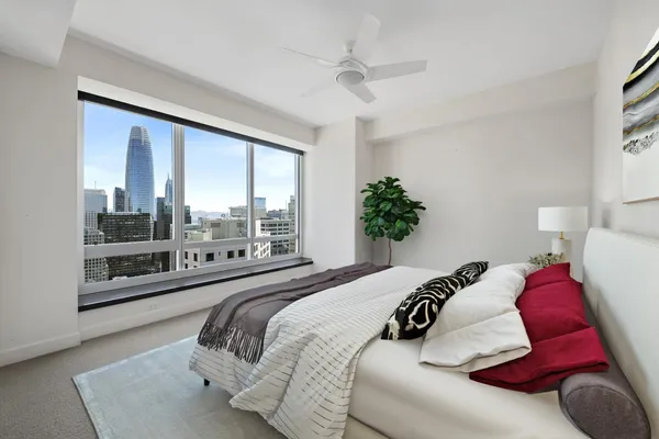 a bedroom with a large bed and a large window