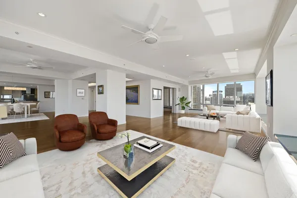 a living room with furniture rug and view of kitchen