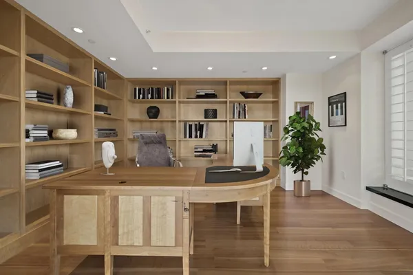 a kitchen with cabinets and wooden floor