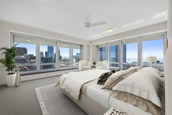 a bedroom with a large bed and a large window