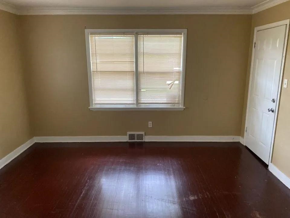729 East Raines Road Memphis, TN 38116 - Photo 3 of 5 Unfurnished room with ornamental molding and dark hardwood / wood-style flooring