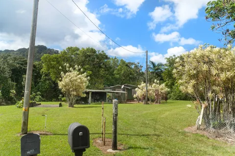 a view of a pathway with a wrought fence