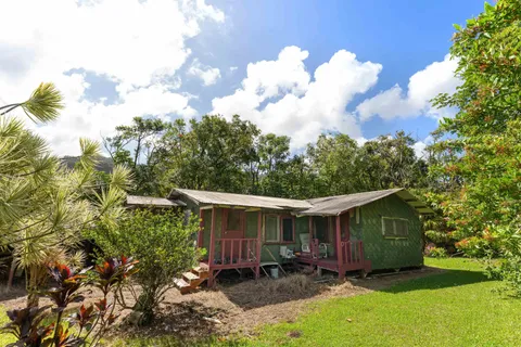 a backyard of a house with table and chairs