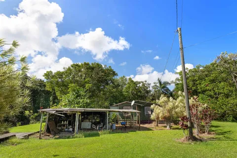 a view of house with swimming pool and sitting area