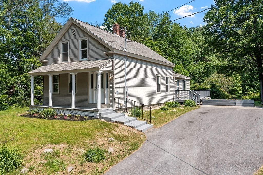 197 Beaman Road Sterling, MA 01564 - Photo 1 of 39 a front view of house with a garden and patio