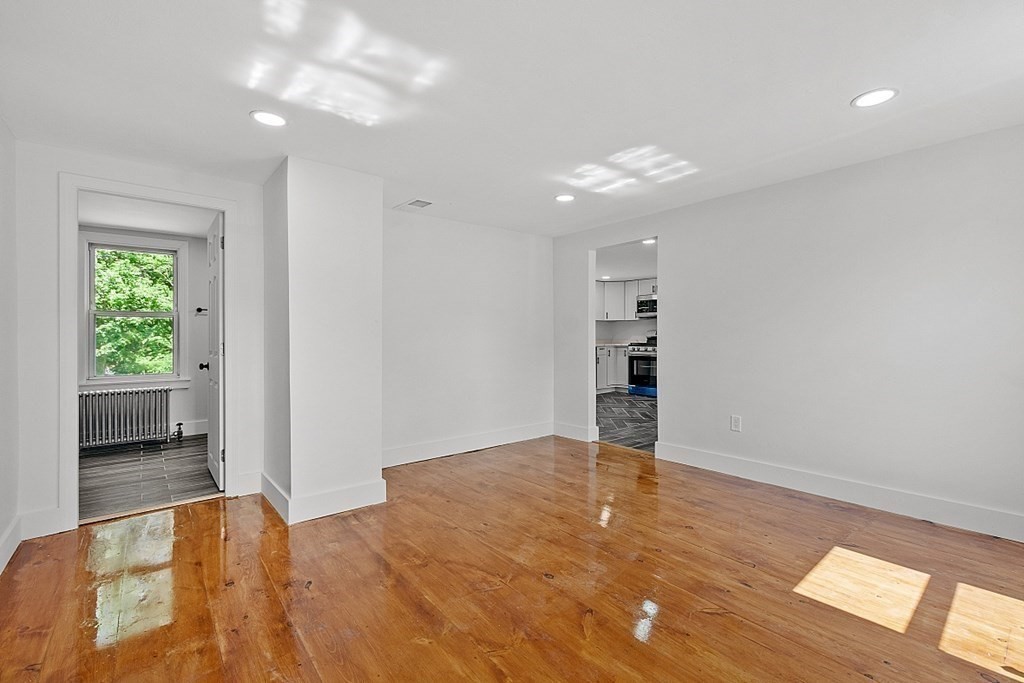 197 Beaman Road Sterling, MA 01564 - Photo 17 of 39 a view of an empty room with window and wooden floor
