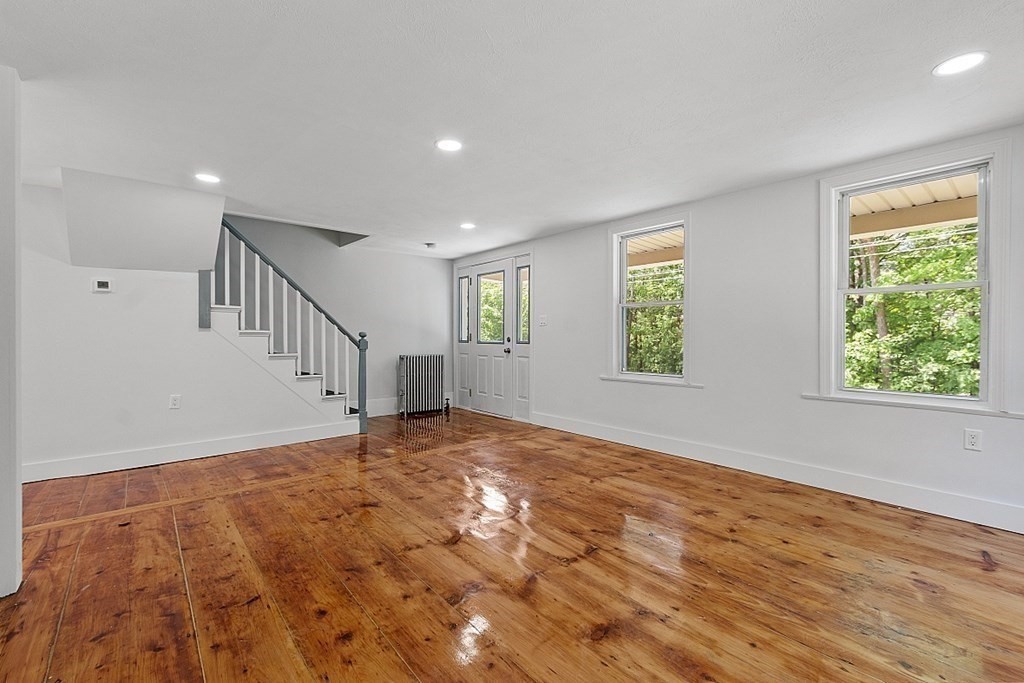 197 Beaman Road Sterling, MA 01564 - Photo 20 of 39 a view of an empty room with wooden floor and a window