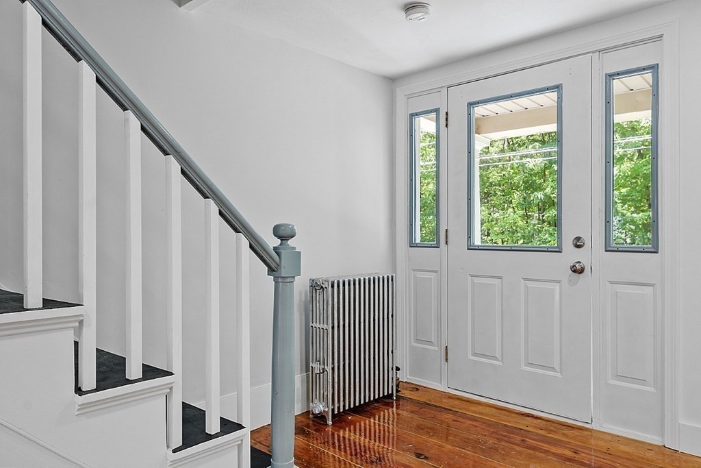 197 Beaman Road Sterling, MA 01564 - Photo 21 of 39 a view of an entryway with wooden floor and staircase