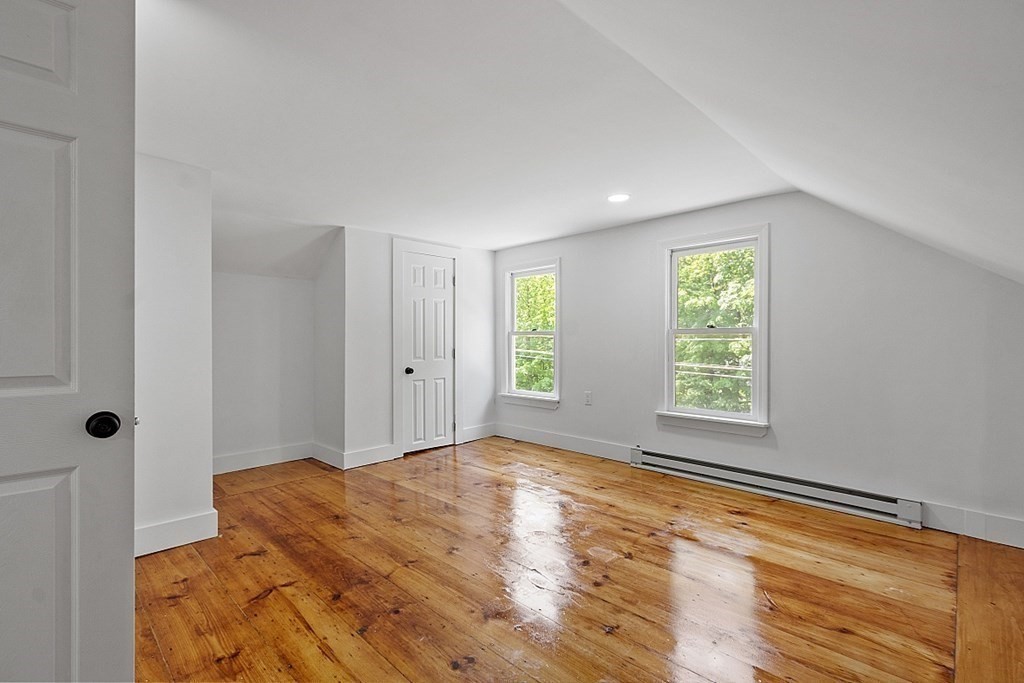 197 Beaman Road Sterling, MA 01564 - Photo 22 of 39 a view of a bedroom with wooden floor and window