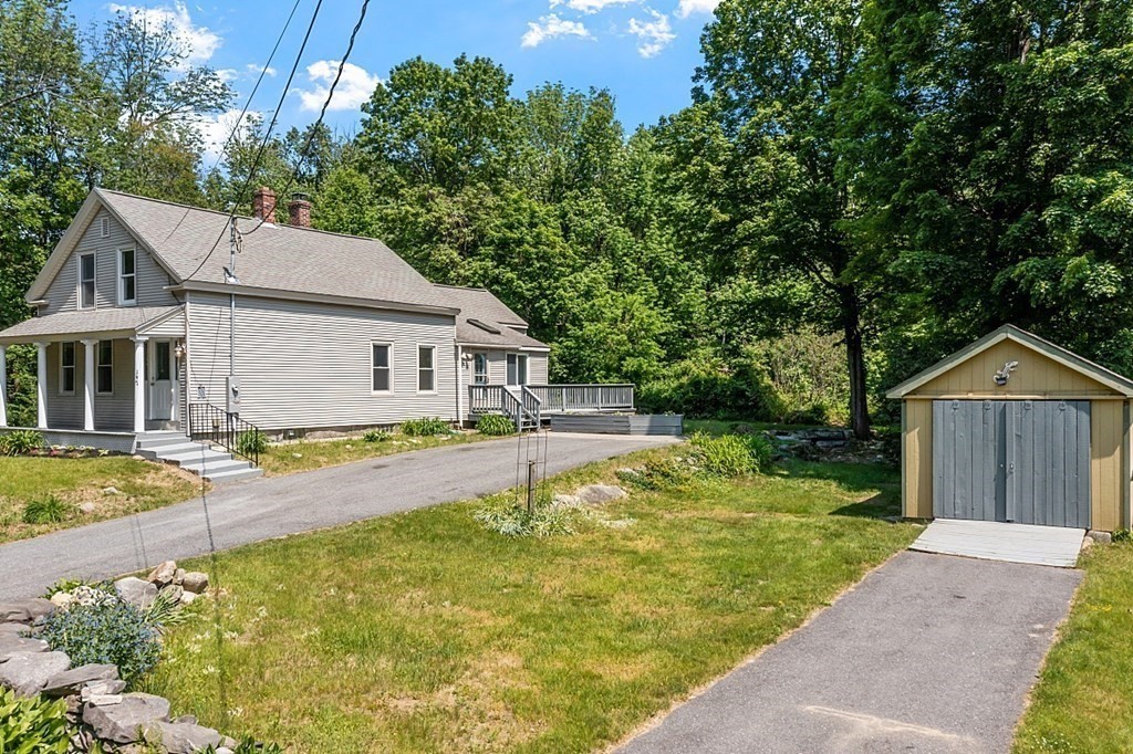 197 Beaman Road Sterling, MA 01564 - Photo 30 of 39 a front view of house with yard swimming pool and green space