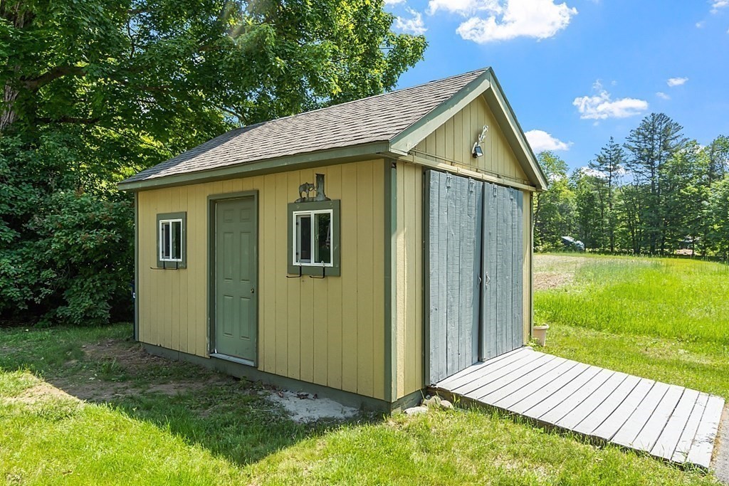 197 Beaman Road Sterling, MA 01564 - Photo 36 of 39 a view of backyard of house with outdoor seating and trampoline