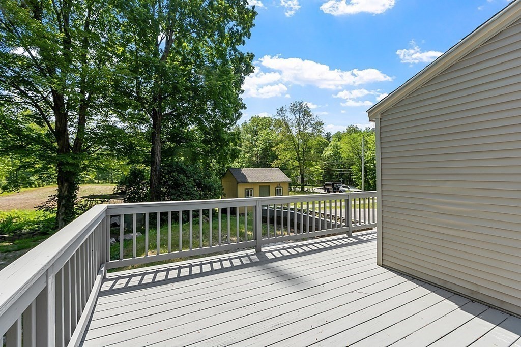 197 Beaman Road Sterling, MA 01564 - Photo 4 of 39 a view of balcony with wooden floor and fence