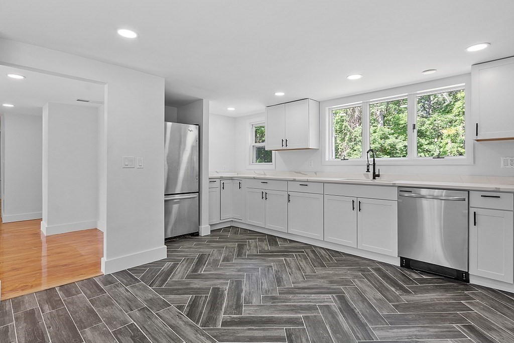 197 Beaman Road Sterling, MA 01564 - Photo 7 of 39 a kitchen with a sink cabinets stainless steel appliances and a window