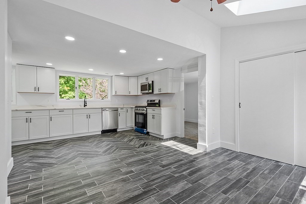 197 Beaman Road Sterling, MA 01564 - Photo 10 of 39 a kitchen with a refrigerator and window