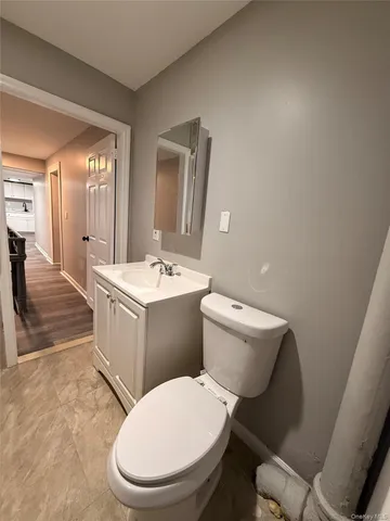 a bathroom with a toilet a sink and a mirror