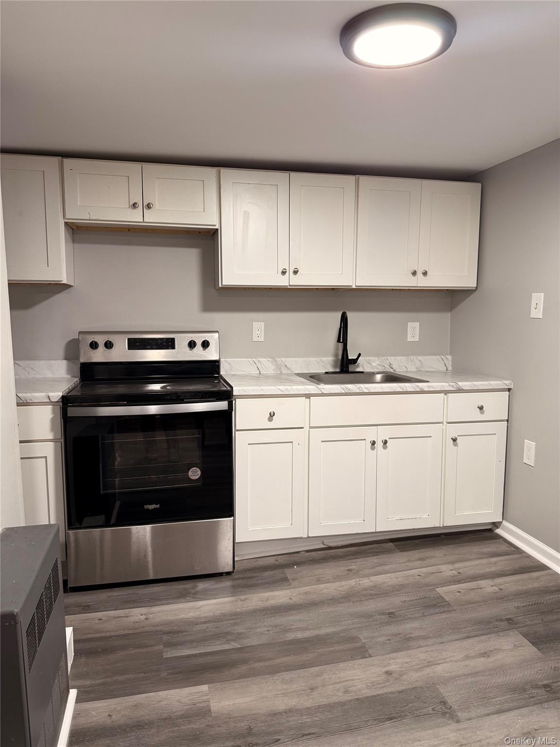 7 Grant Street, Unit 2 Poughkeepsie, NY 12601 - Photo 13 of 13 a kitchen with a stove a sink and a microwave