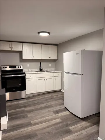 a kitchen with wooden cabinets and white appliances