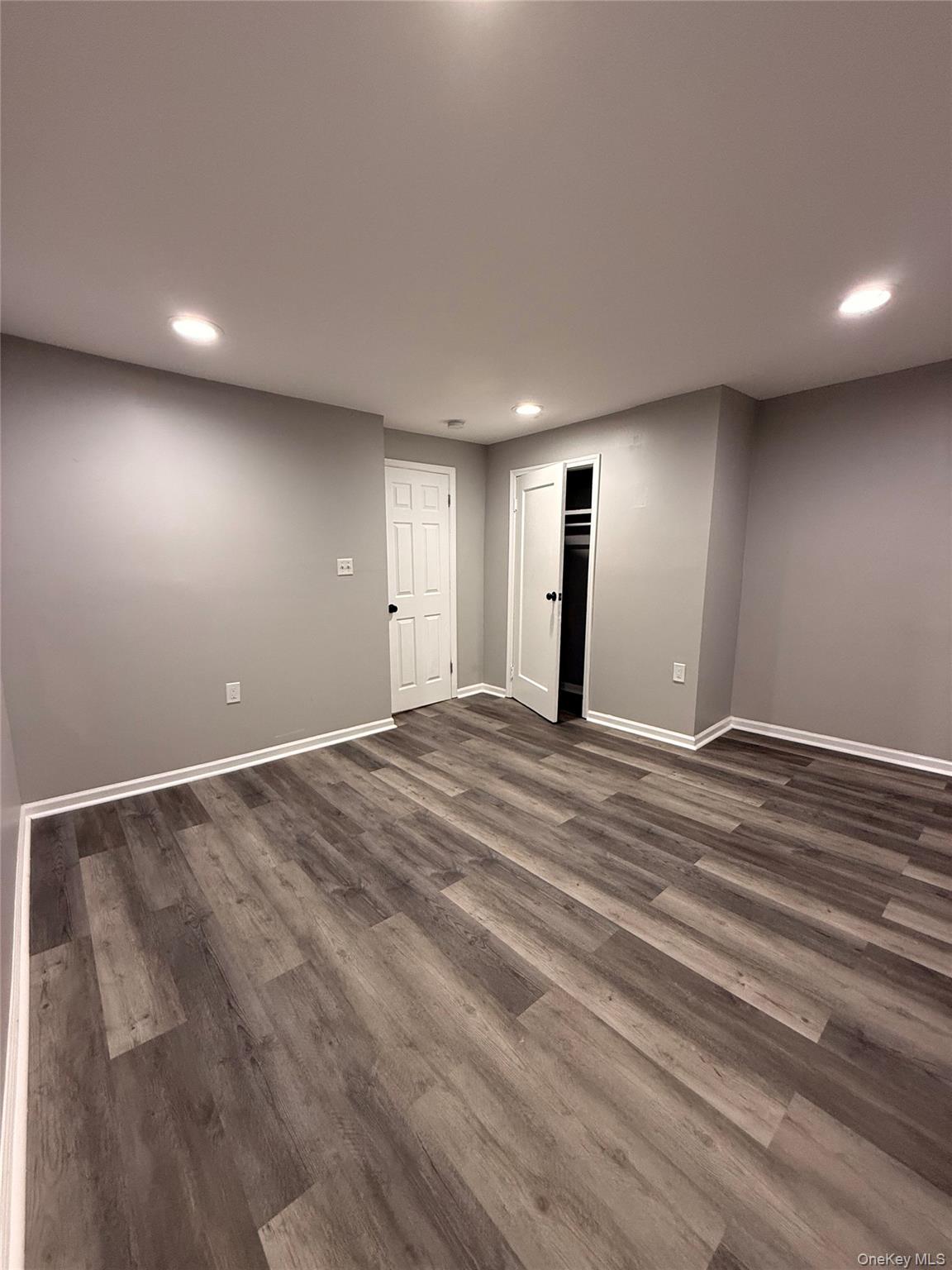 7 Grant Street, Unit 2 Poughkeepsie, NY 12601 - Photo 6 of 13 an empty room with wooden floor and window