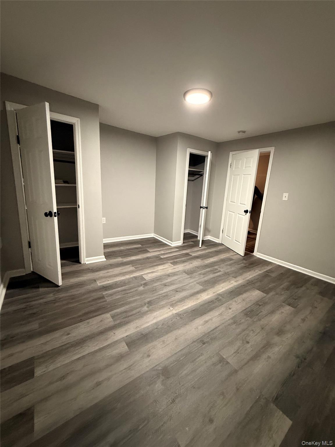 7 Grant Street, Unit 2 Poughkeepsie, NY 12601 - Photo 8 of 13 an empty room with wooden floor and white walls