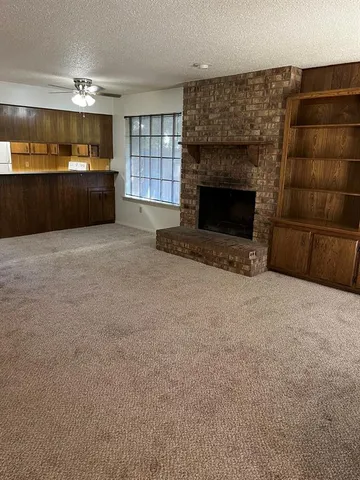 a living room with a fireplace and a window