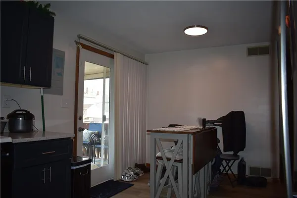 a view of a workspace with furniture and a window