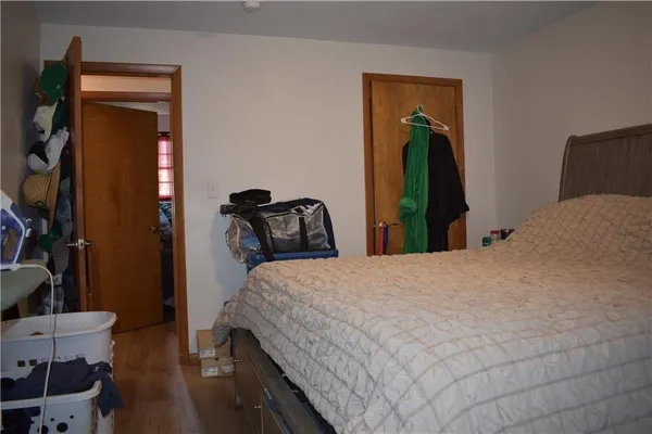 a bedroom with a bed and a mirror