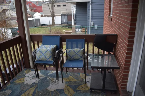 a view of a chairs and table in the balcony