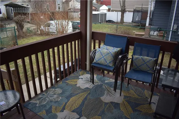 a view of a patio with table and chairs and barbeque stove