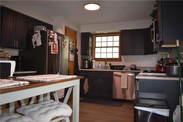 a kitchen with a table chairs and refrigerator