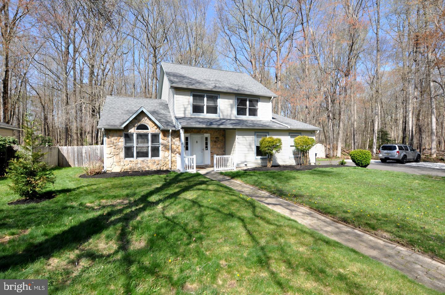 a front view of a house with a garden and porch