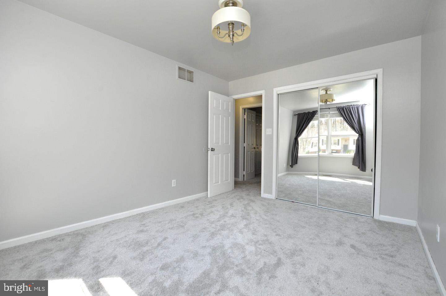 45 Sherri Way Pine Hill, NJ 08021 - Photo 20 of 31 an empty room with chandelier fan and windows