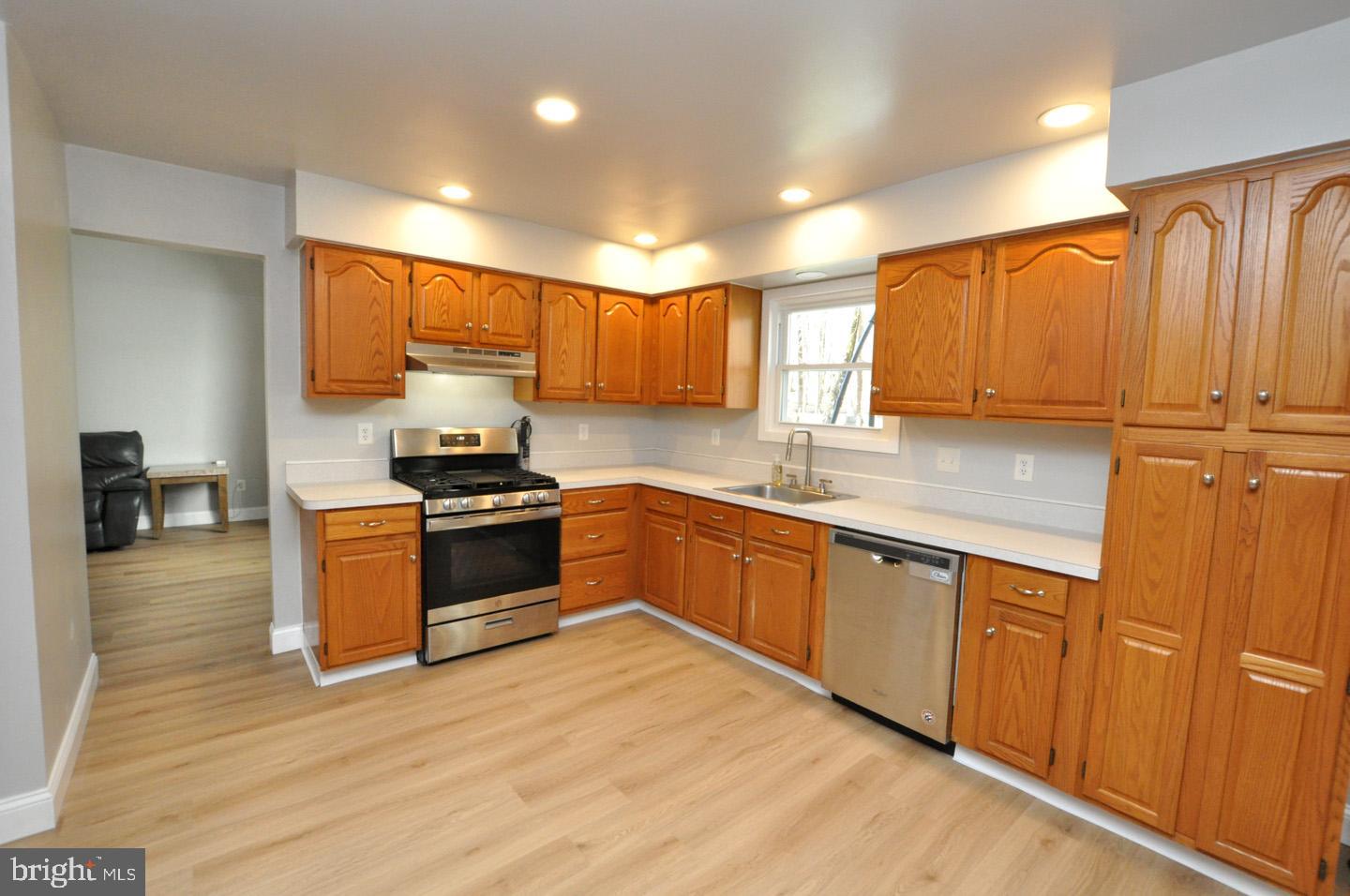45 Sherri Way Pine Hill, NJ 08021 - Photo 7 of 31 a kitchen with stainless steel appliances granite countertop a stove a sink and a refrigerator