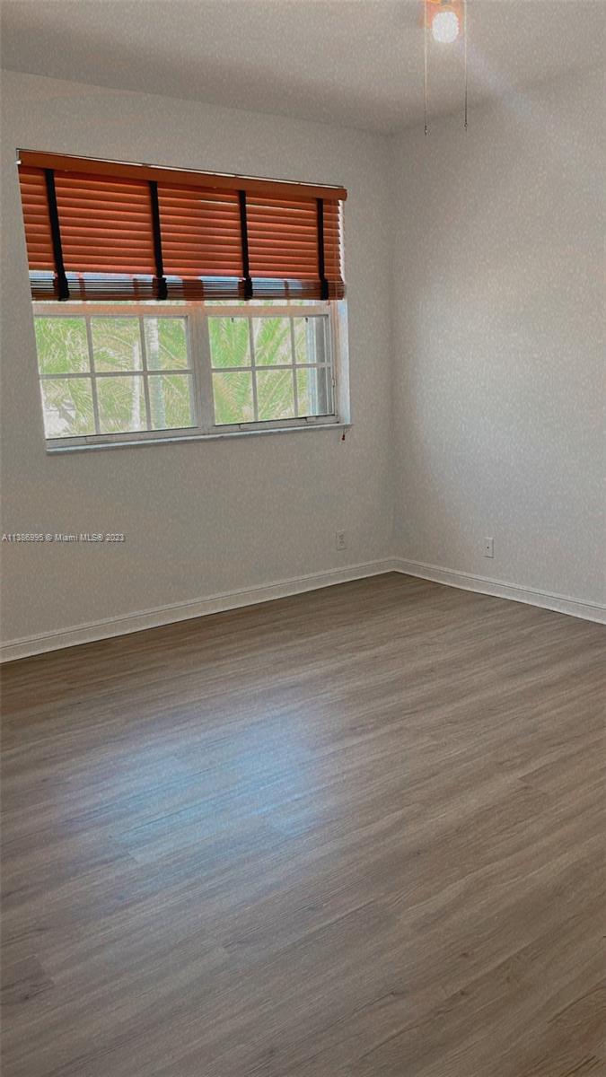 Windsor Palms Miramar, FL 33027 - Photo 20 of 30 a view of an empty room with wooden floor and a window