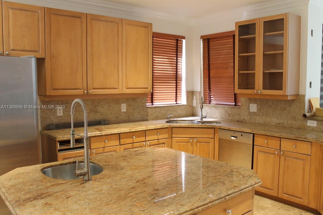 Windsor Palms Miramar, FL 33027 - Photo 9 of 30 a kitchen with stainless steel appliances granite countertop a sink and a window